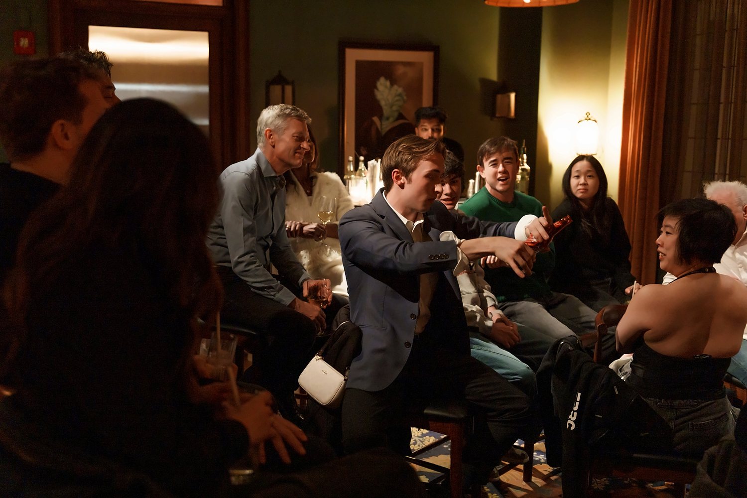 Tom performing for a crowd in a wood-paneled bar
