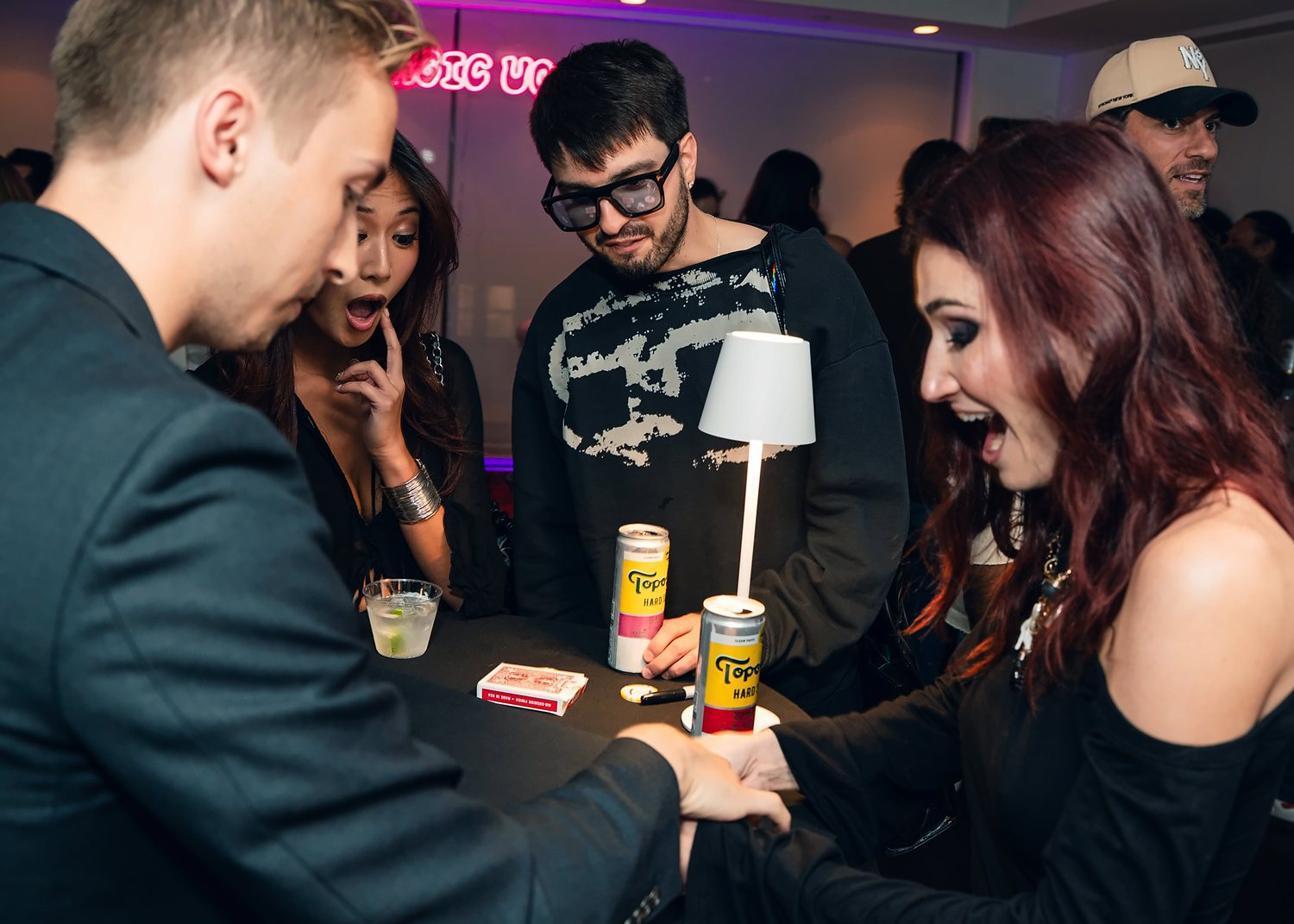 Guests gasping at a cocktail table