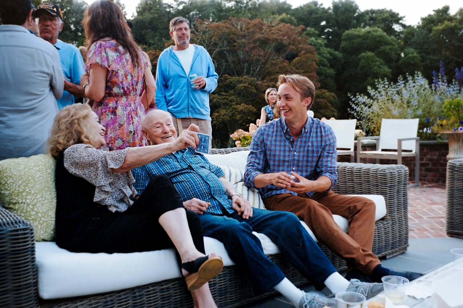 Tom with guests at a garden party
