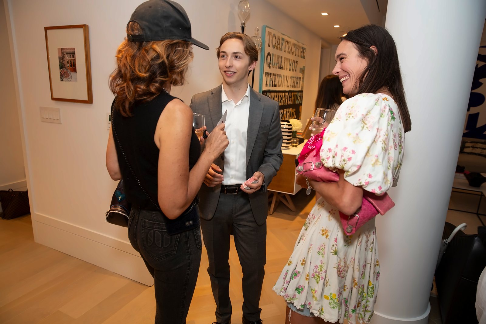 Tom chatting with guests at a gallery party